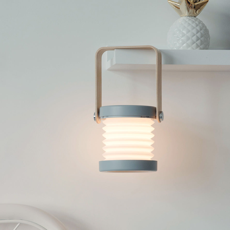 Lampe de nuit LED pliable, tactile et à intensité variable, rechargeable par USB, idéale pour la décoration intérieure.